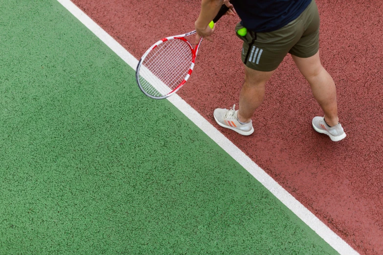 a person standing on top of a tennis court holding a racquet