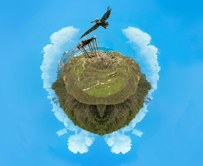 an island with a statue and birds in the sky