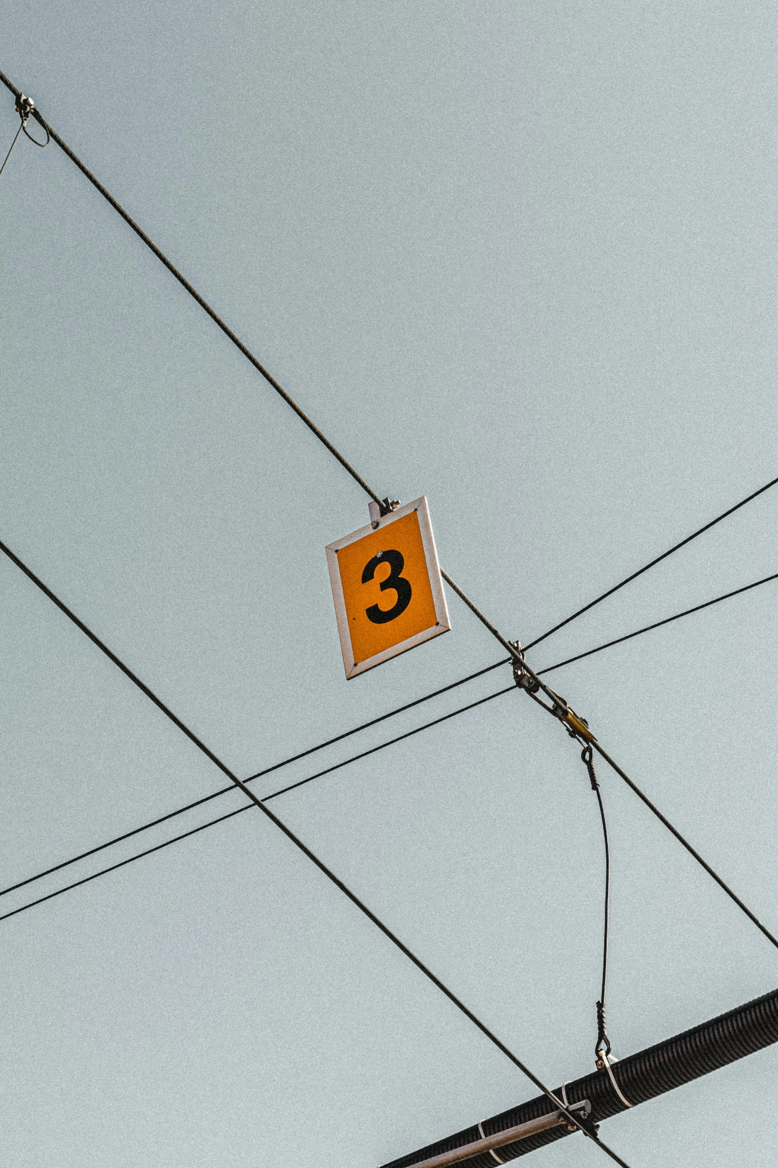 a number sign is posted above power lines