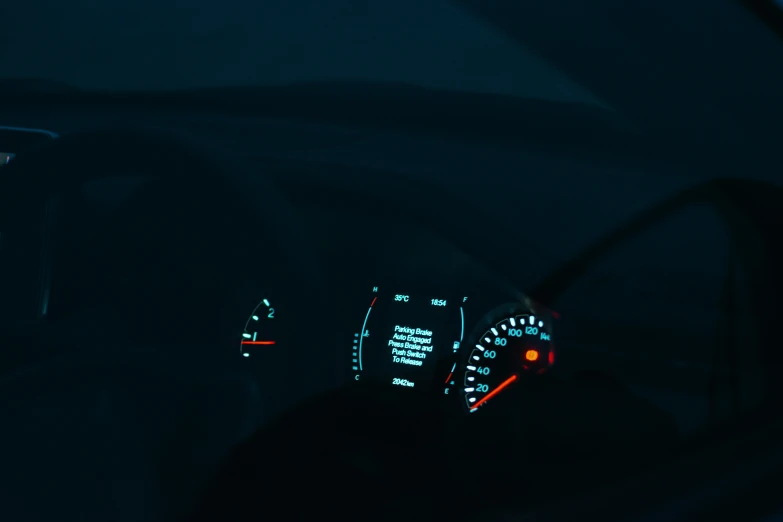 the gauges on a car dashboard are illuminated by green