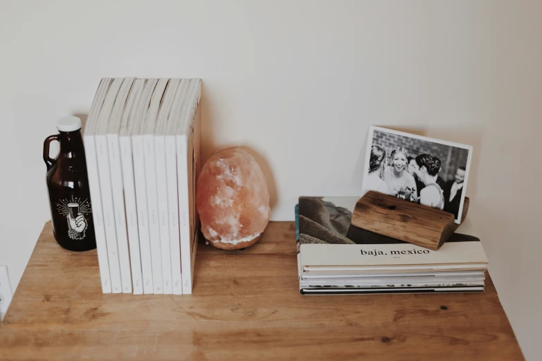 a brown wooden table topped with books and a donut