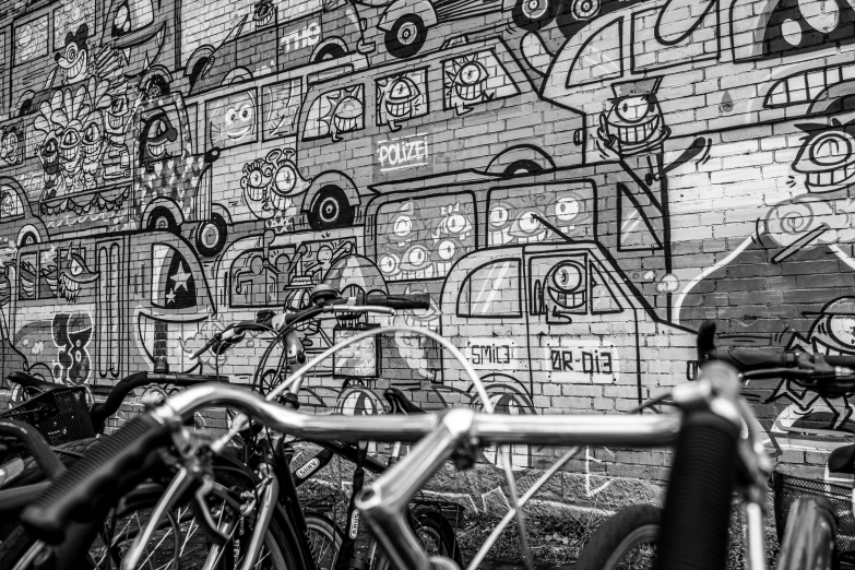 bicycles parked near graffiti on the wall