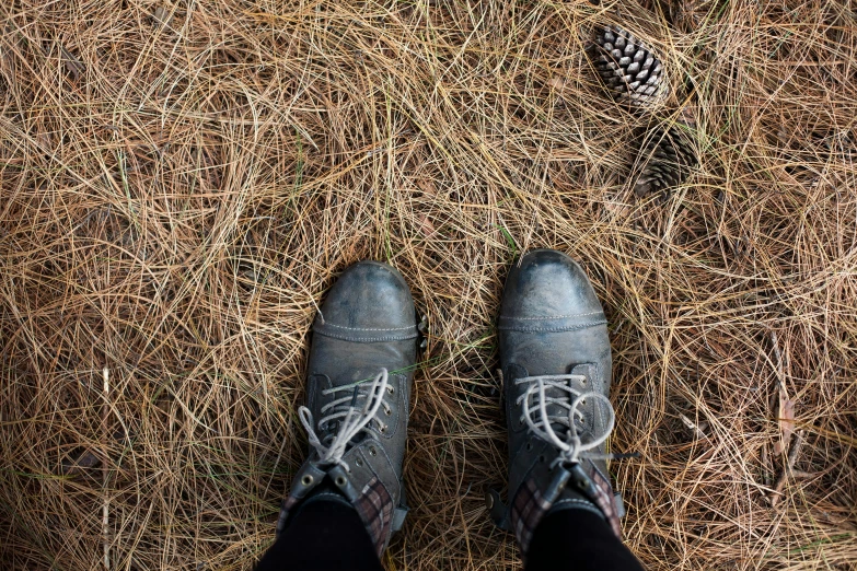 someone is standing on the dry ground with their feet up