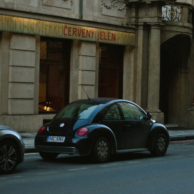 two black cars parked on the street side