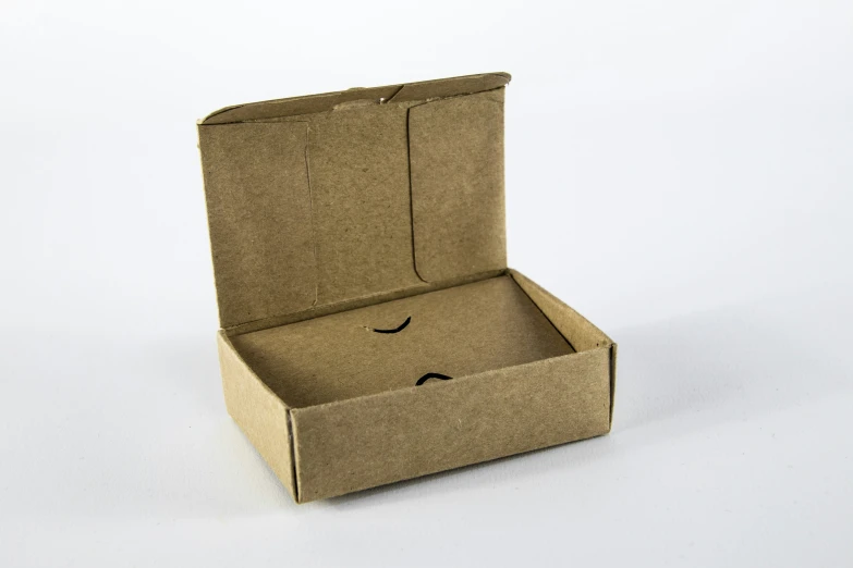 an open cardboard box with a face cut out