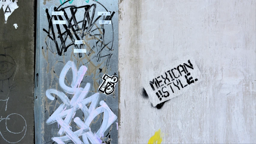 the graffiti on the walls is white with black and yellow designs