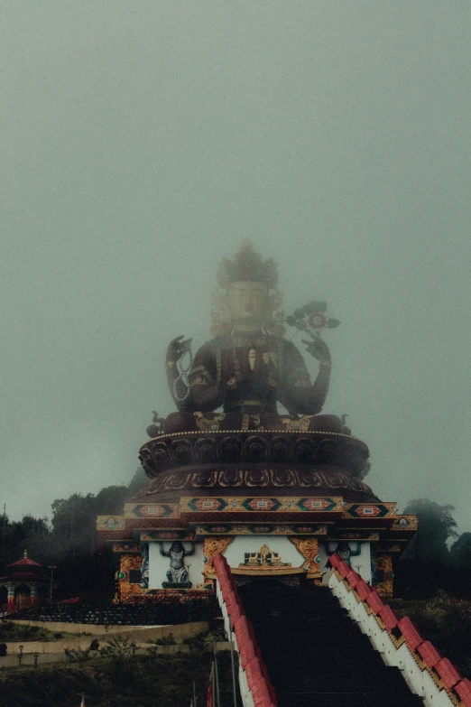 large statue with a steeple standing on top