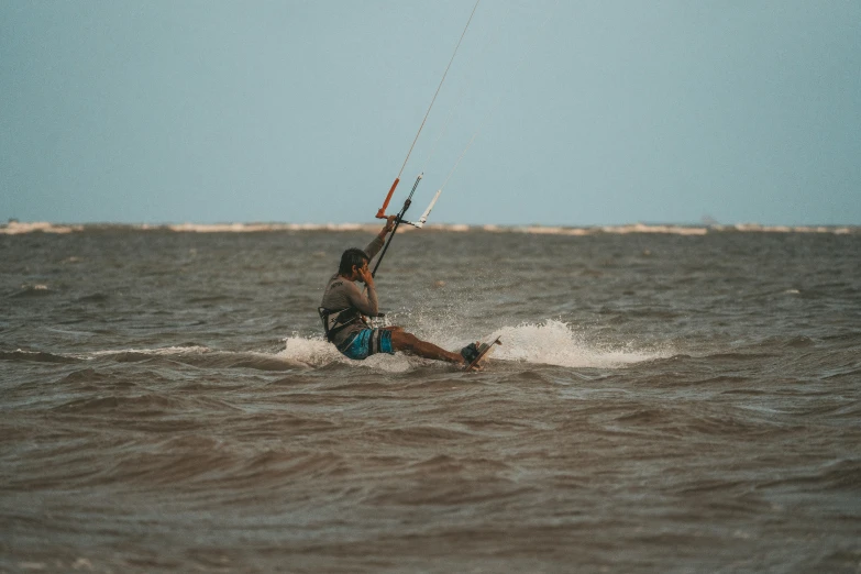 a man riding a surfboard in the ocean while holding onto a handle