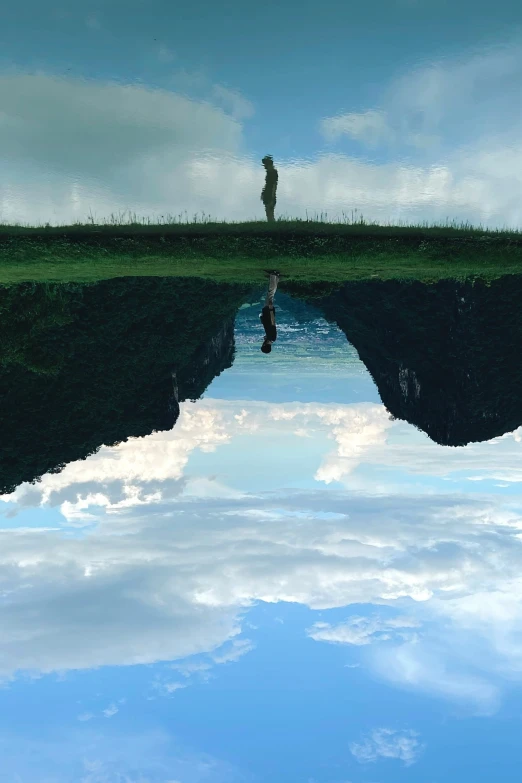 a man standing on top of a bridge over water