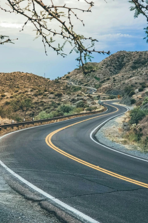 a long curved road in the middle of nowhere