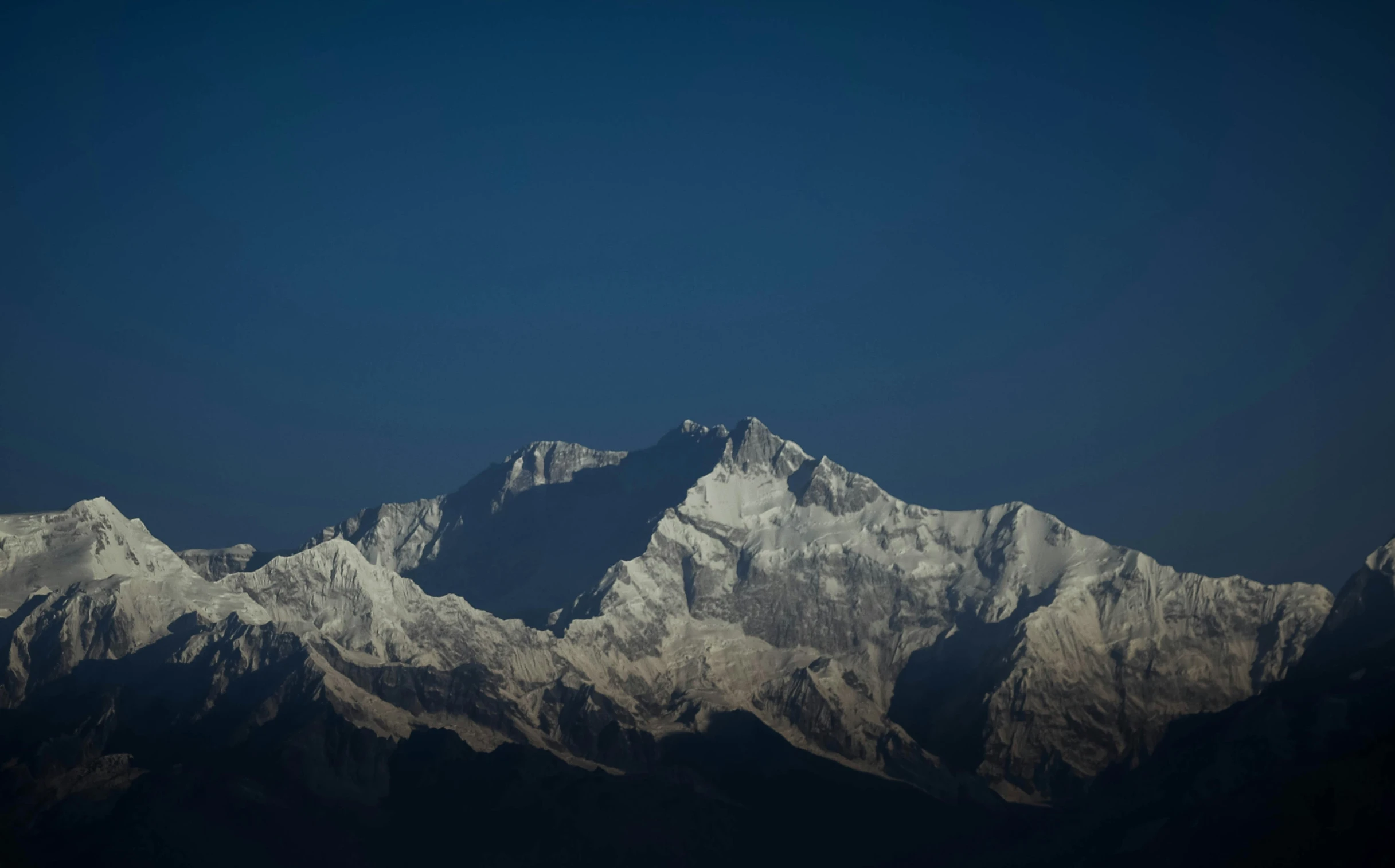 a snowy mountain range is seen from the air