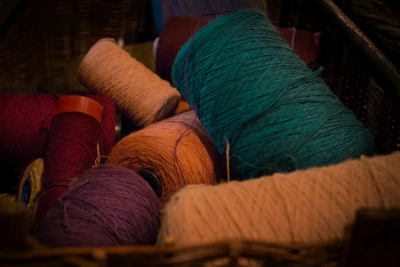 a pile of various colored yarn with wooden handles