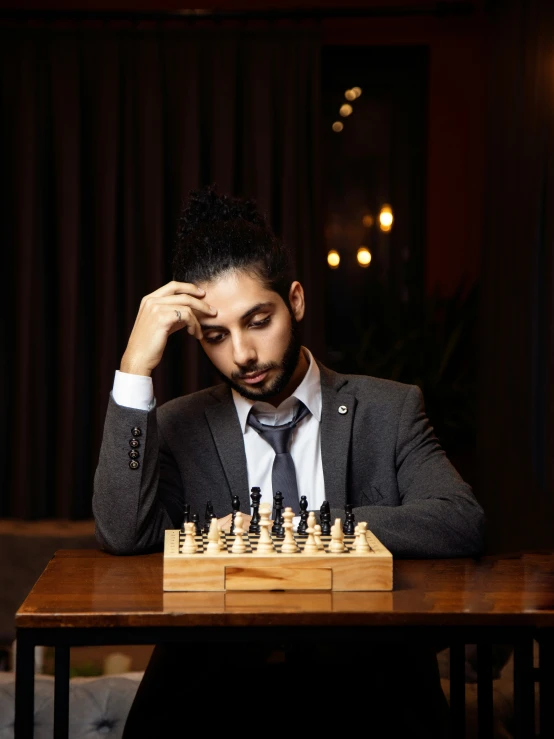 a man in a suit plays chess