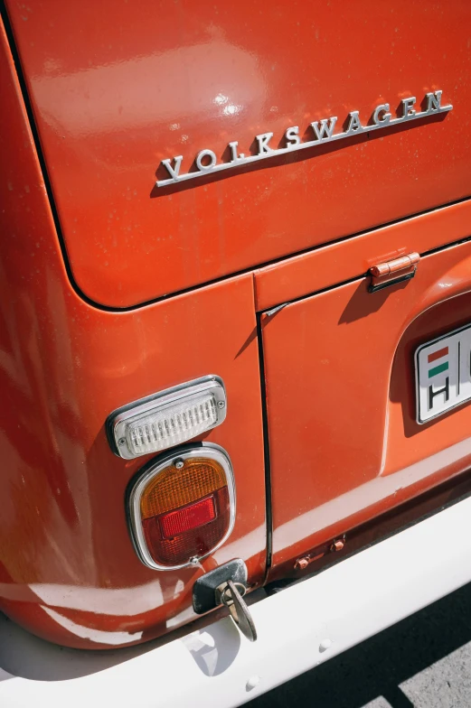 an old orange truck with the word volkswagen on the front