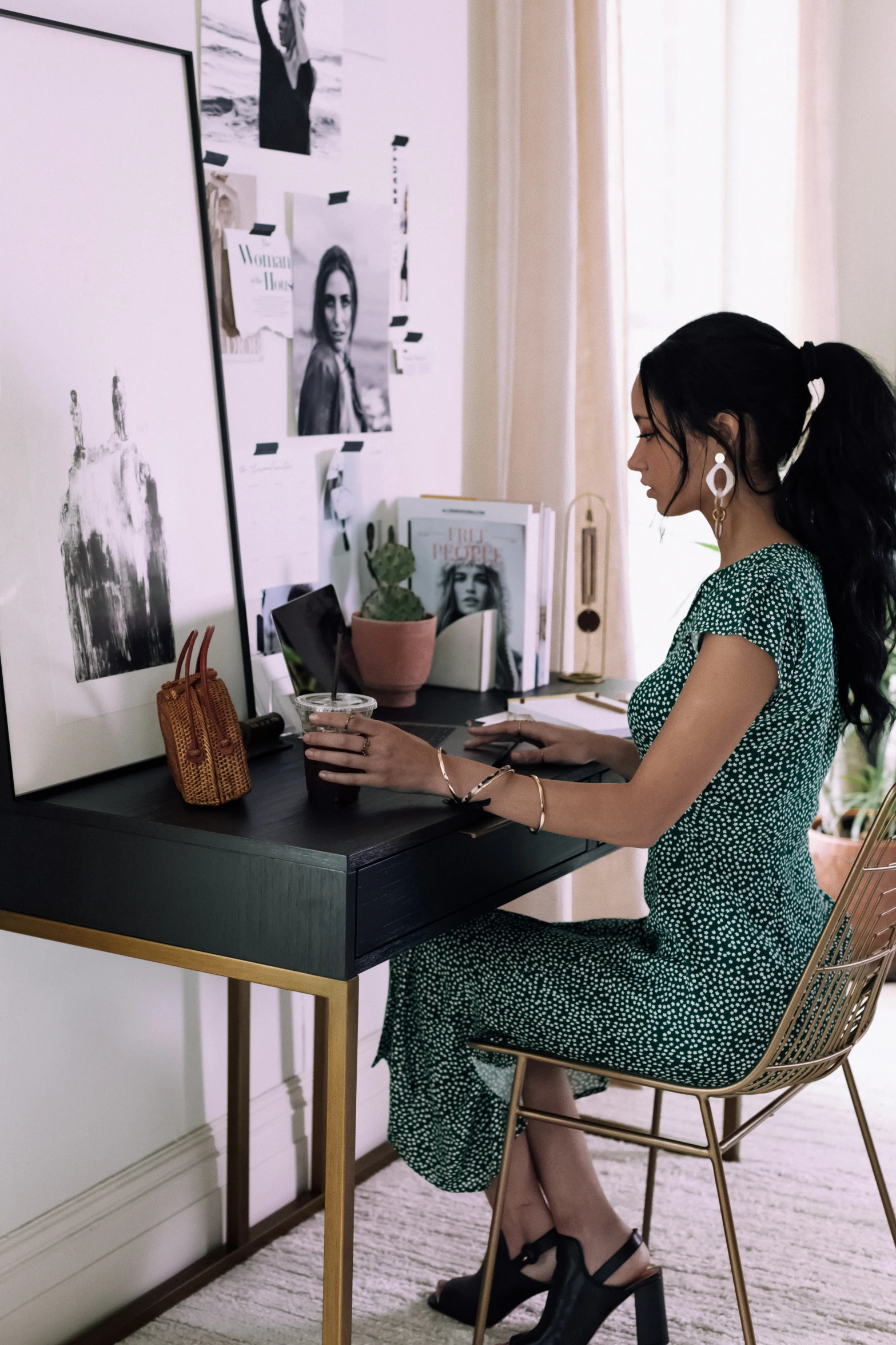 a woman that is sitting at a desk with a computer