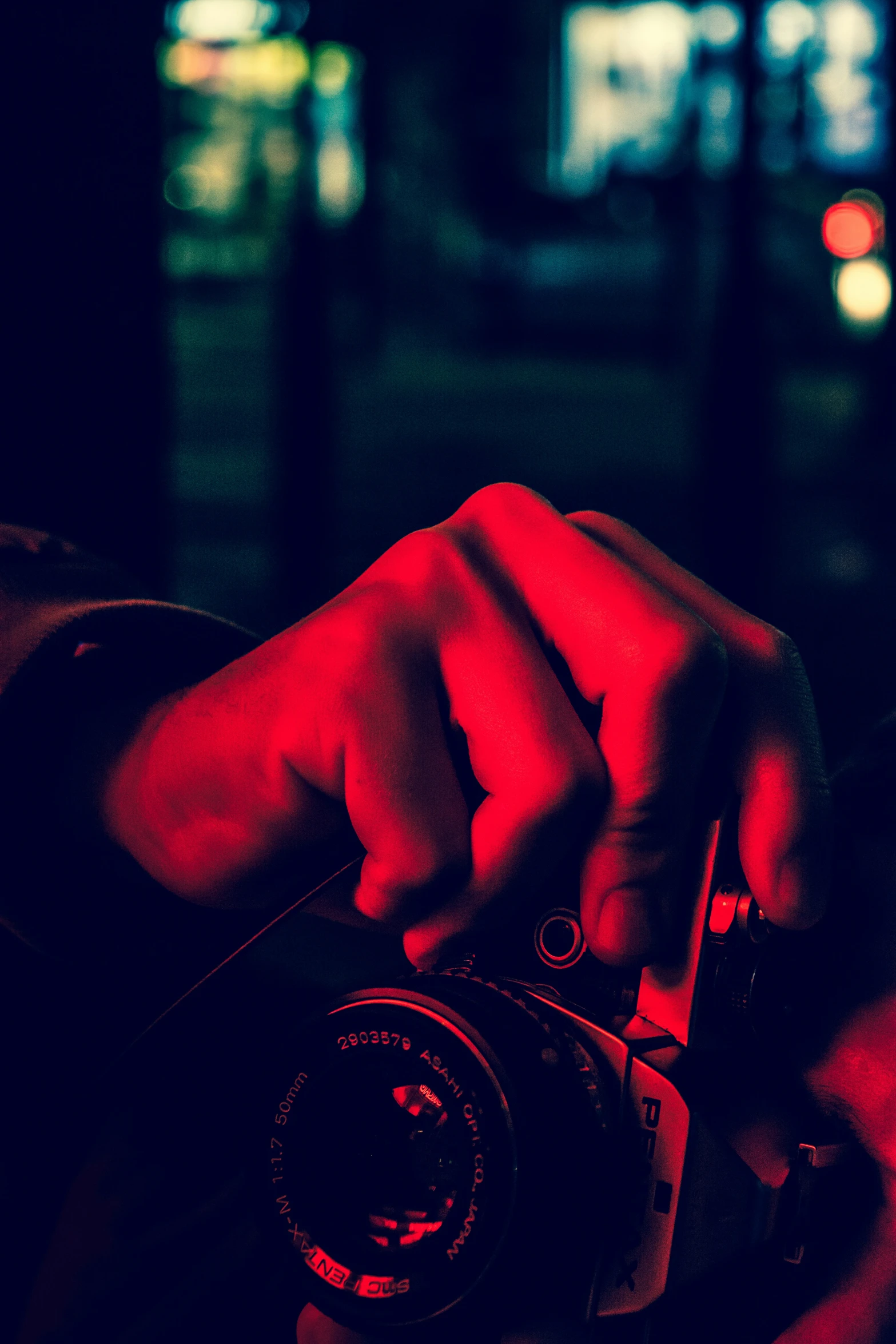 the hand on a black and red pograph holding a camera