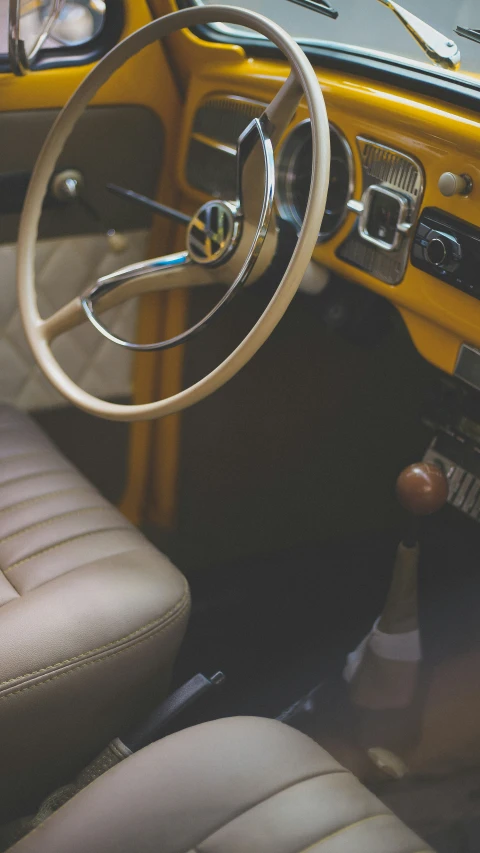 the steering wheel and dashboard of an old vintage car