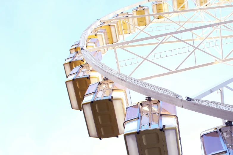 a ferris wheel sitting next to the top of a tall building