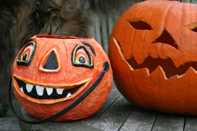 two pumpkin heads sitting on top of a wooden table