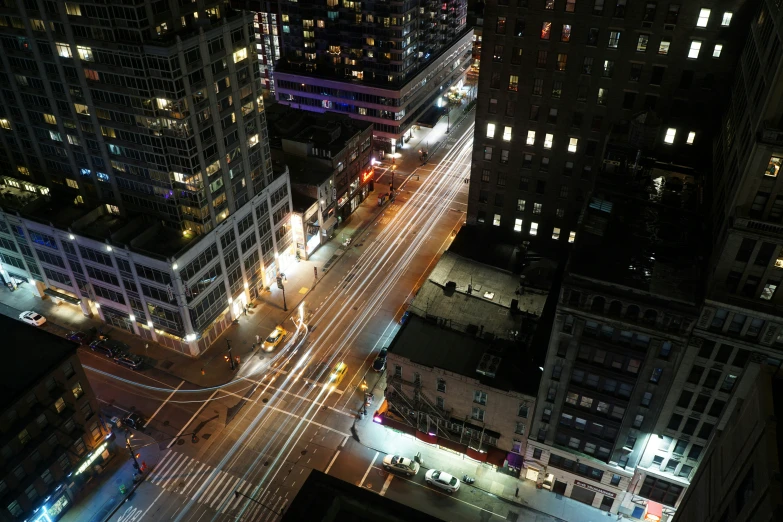 aerial view of city at night with cars turning