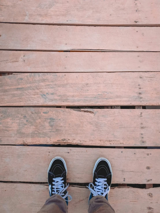 the feet of a person standing on a deck