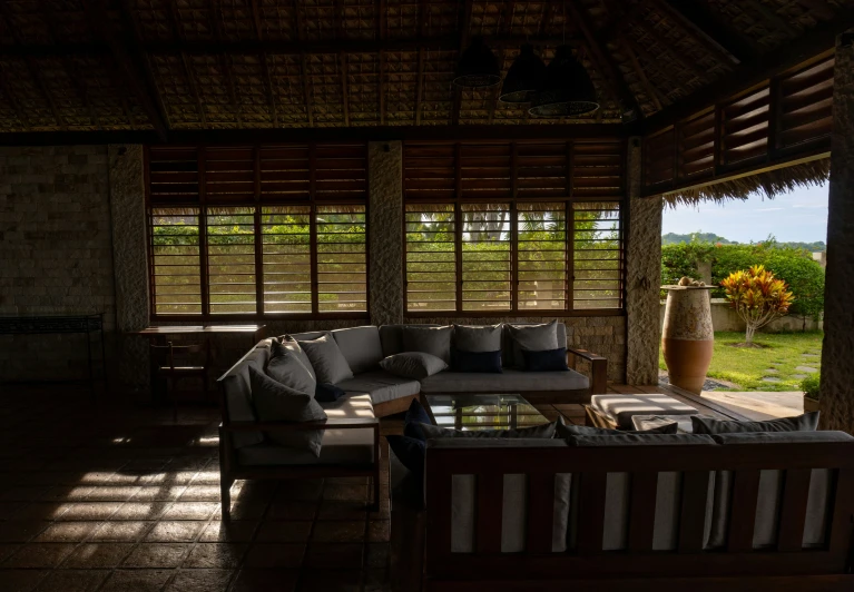 a room with wooden floors and sofas in it