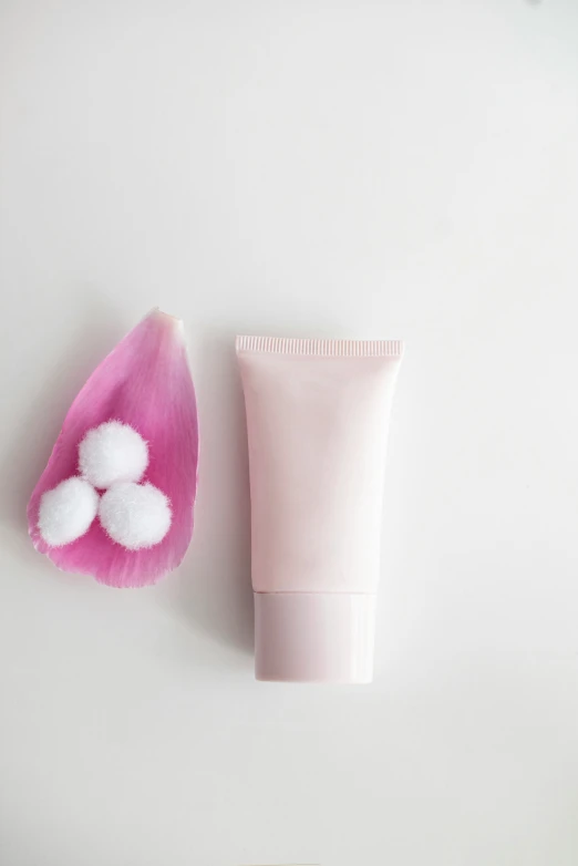 a tube of hand cream, and two plastic petals