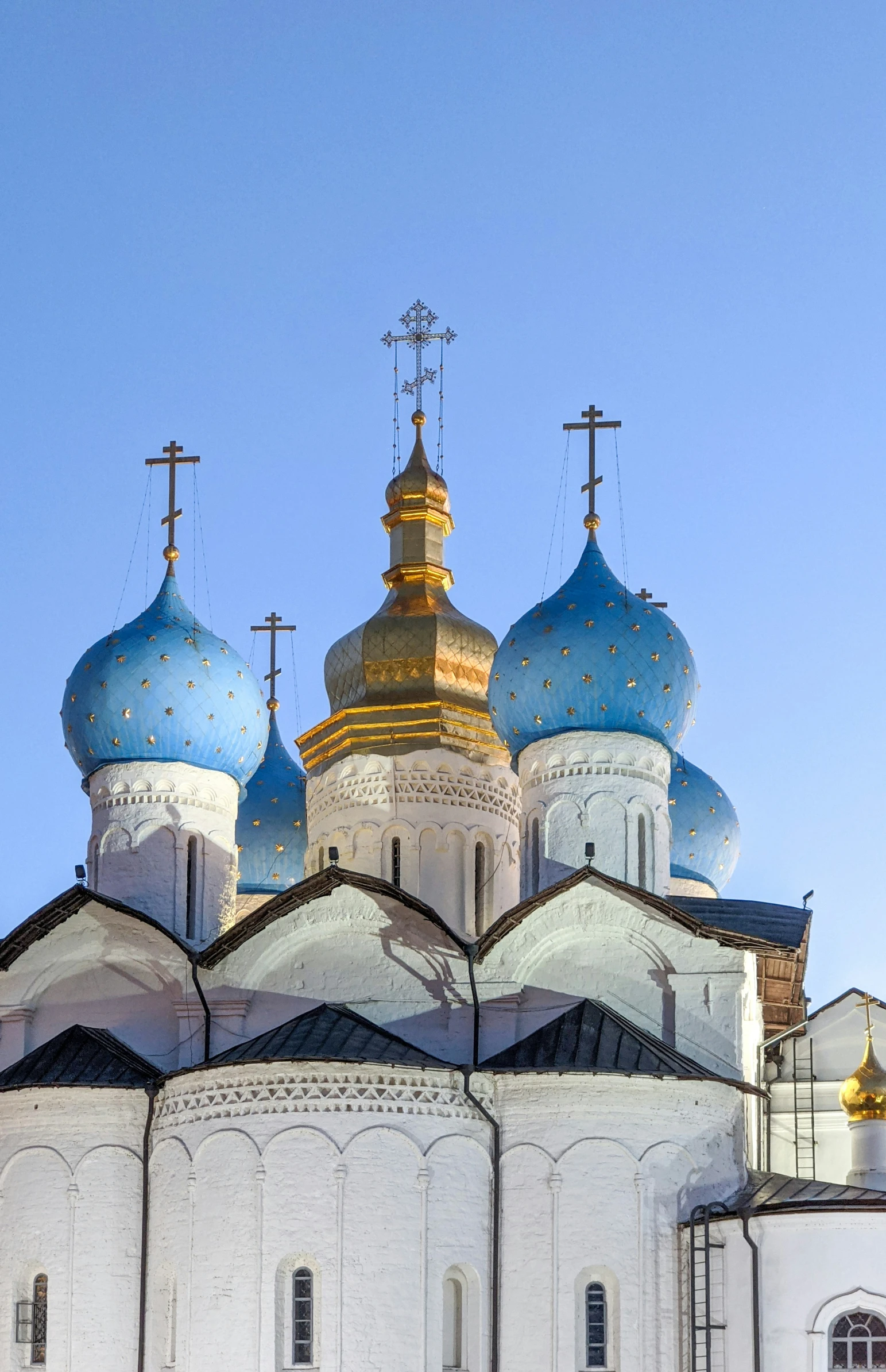 a large cathedral with four rows of blue domes