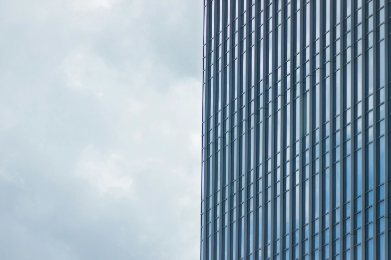 the airplane flies behind a building with a blue sky background