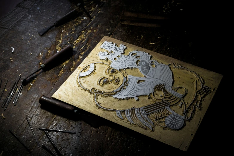 a gold - colored artwork piece with a lion design