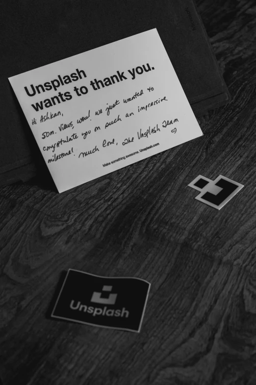 a black and white po with a note reading'unplash wants to thank you '