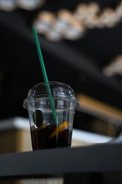 a cup with two straws and a drink