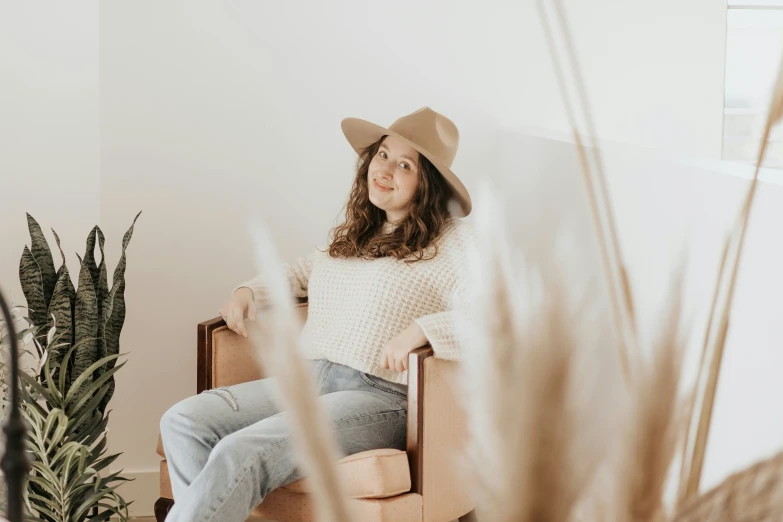 the woman is wearing a hat in her room