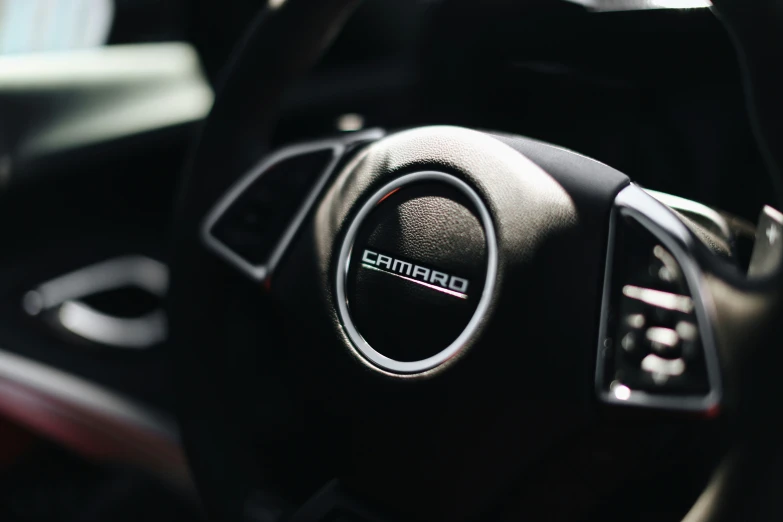 a close up po of the steering wheel in a car