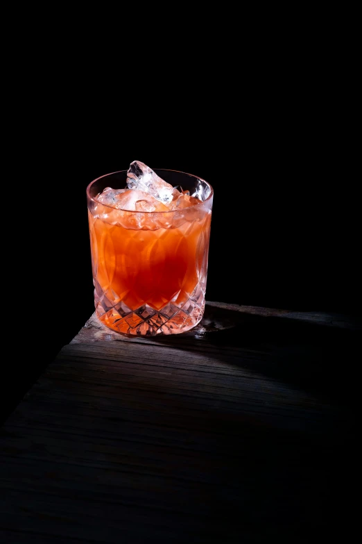 a glass on a table that is sitting in the sunlight