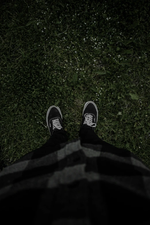 a persons feet resting on the grass in the middle of the day