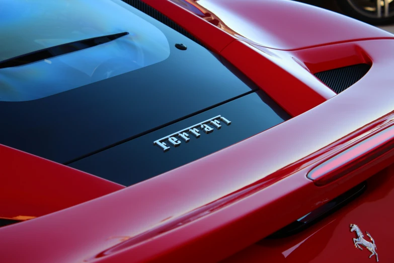 a ferrari logo is shown on the hood of a red car