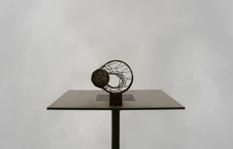 a metal spinning object that is on top of a stand