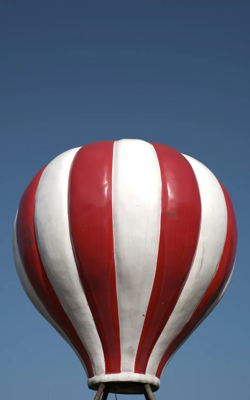 a red and white striped water tower