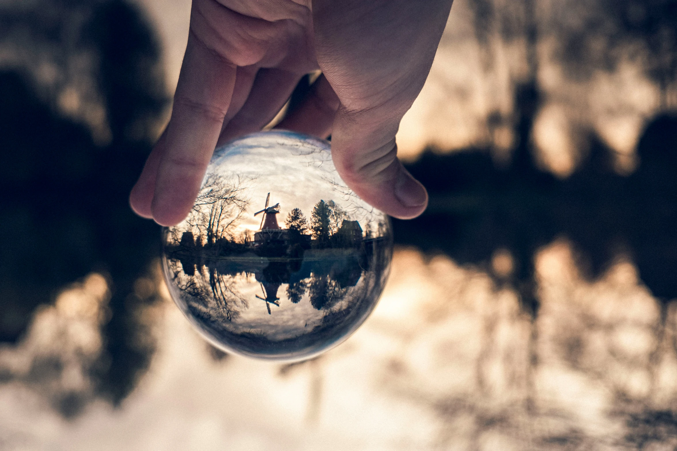 someone's reflection in the side of a ball