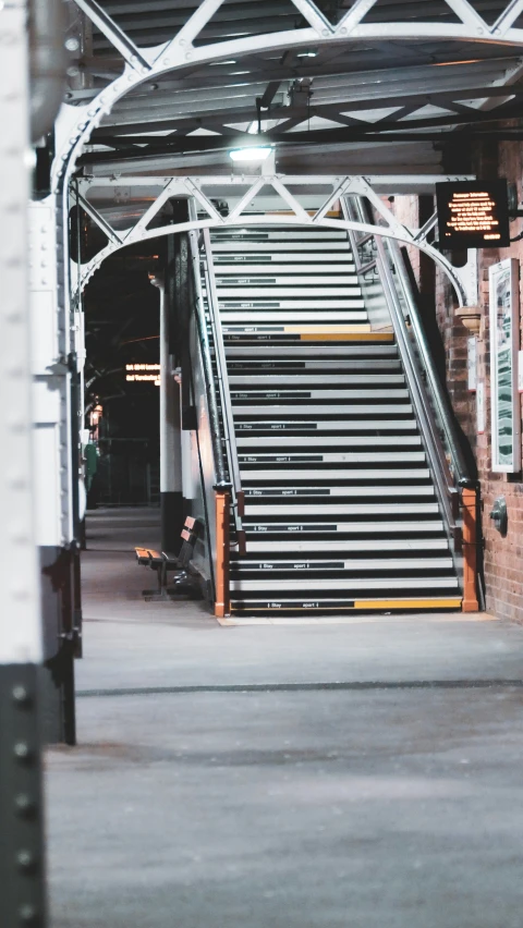 a staircase with two people sitting on the steps