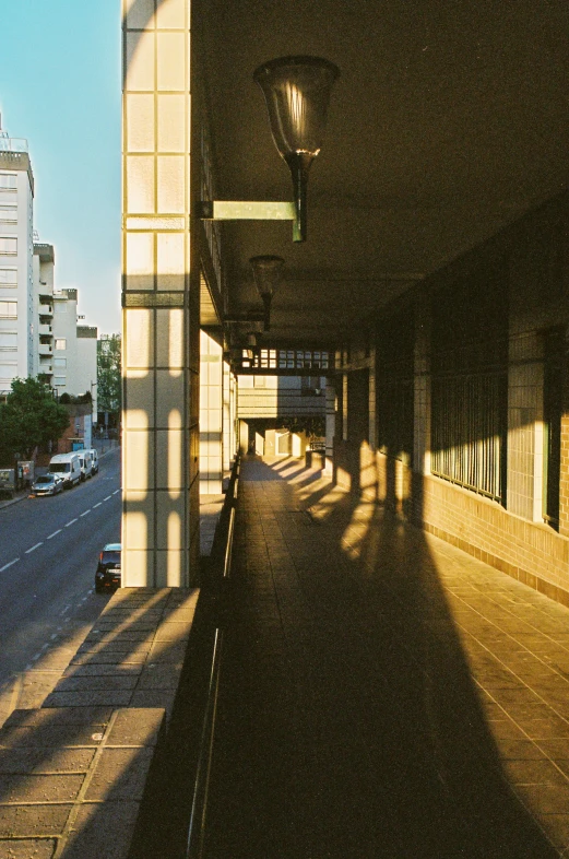 a city street lined with tall buildings next to a sidewalk