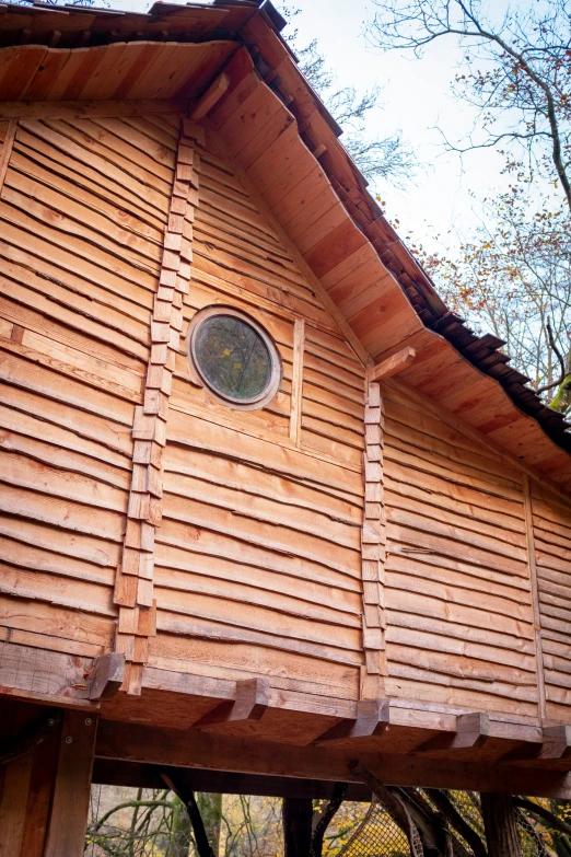 small wooden structure with tree outside during day