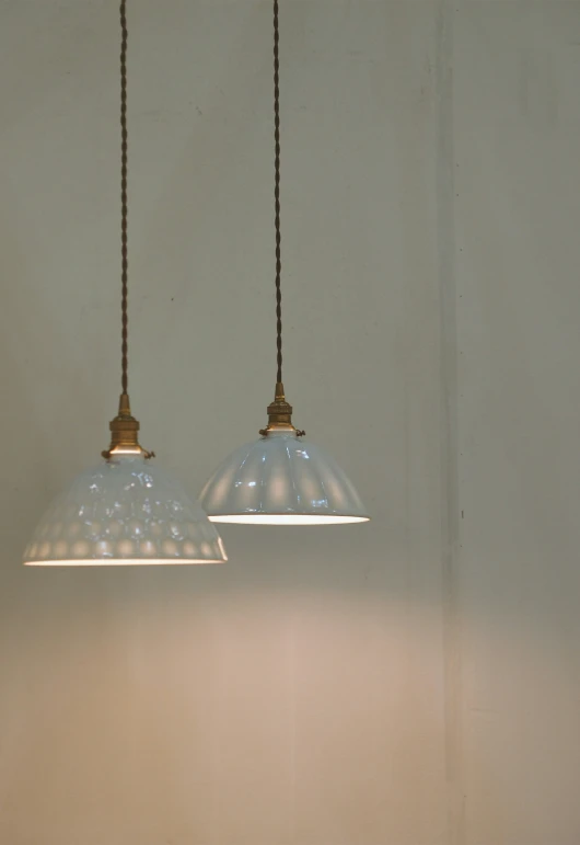 two small glass lights hanging above each other