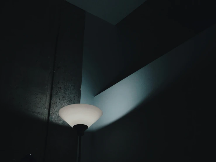 a lamp in the corner of a dark room