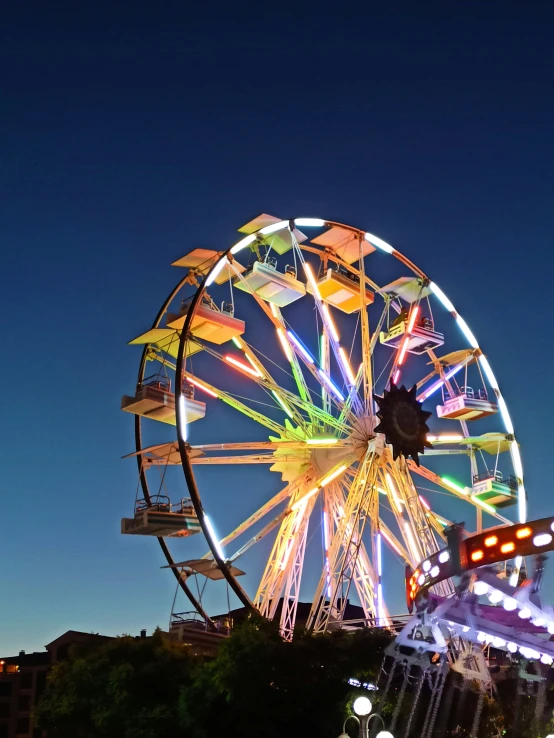 a large ferris wheel lit up at night