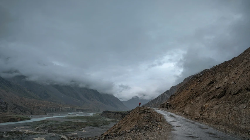 a lone road in the middle of the mountain