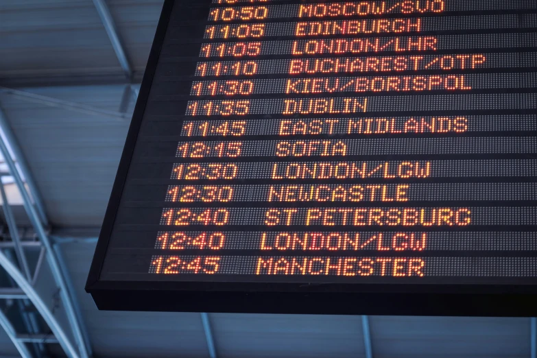 a sign showing the direction to different trains