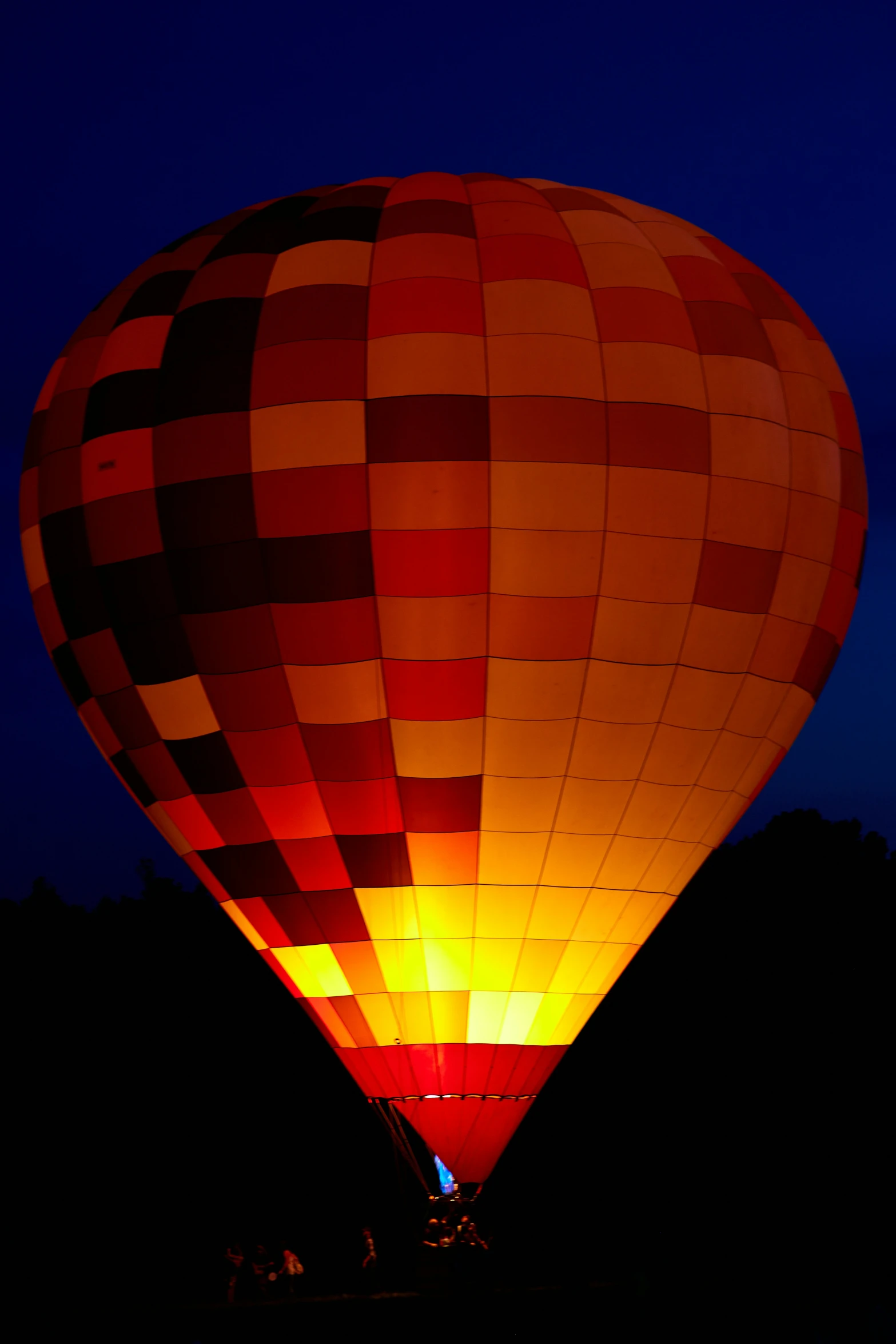 a big  air balloon illuminated in the sky