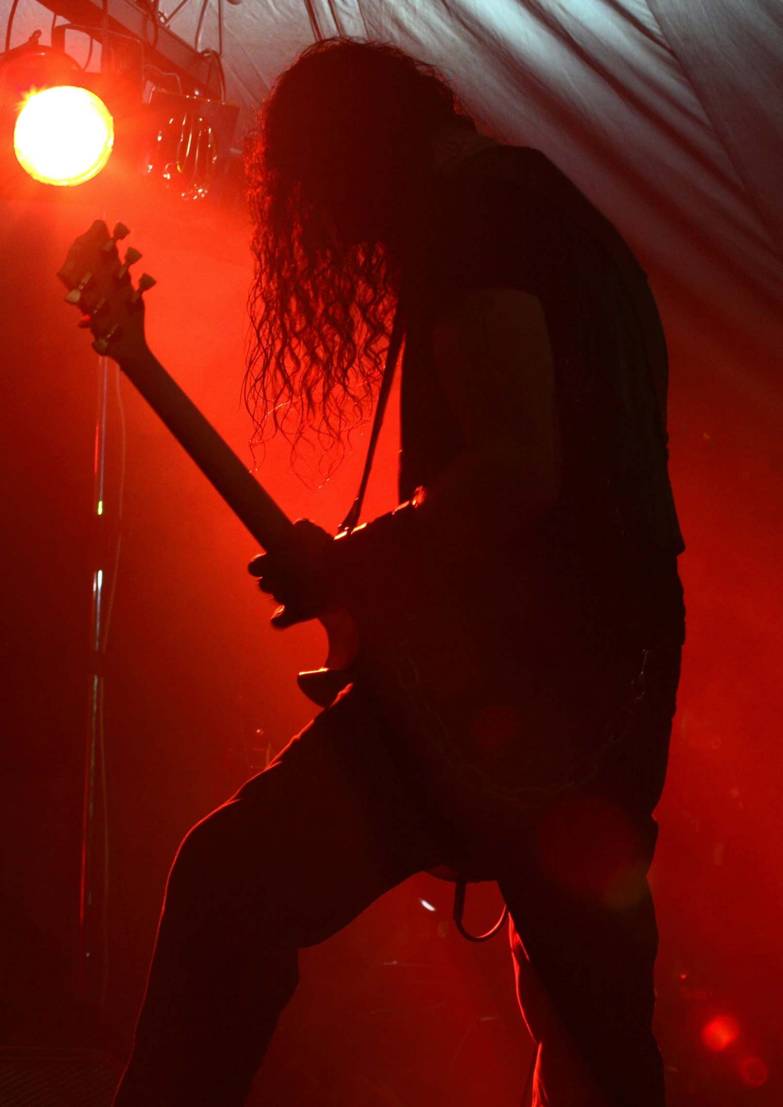 a man with long curly hair plays guitar